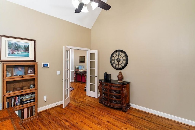 interior space with french doors, hardwood / wood-style flooring, high vaulted ceiling, and ceiling fan