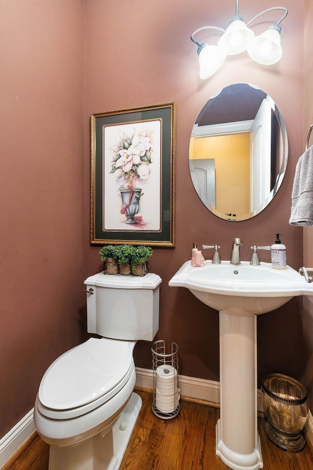 bathroom featuring wood-type flooring and toilet