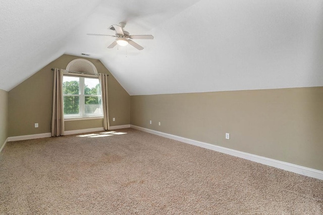 bonus room with carpet flooring, ceiling fan, and lofted ceiling