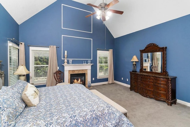 bedroom with carpet flooring, ceiling fan, a fireplace, and high vaulted ceiling