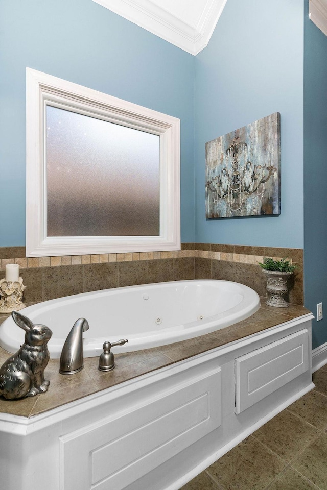 bathroom with a bathing tub, tile patterned flooring, and crown molding