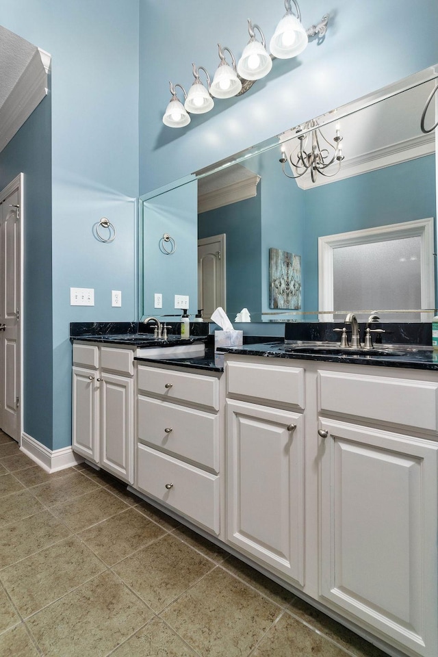 bathroom featuring tile patterned flooring, vanity, and an inviting chandelier