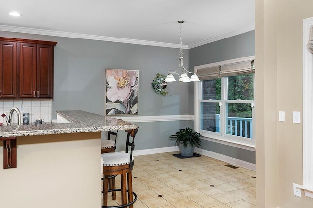 unfurnished dining area with ornamental molding, sink, light tile patterned floors, and an inviting chandelier