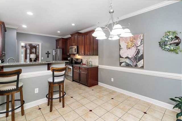 kitchen featuring light stone counters, crown molding, decorative light fixtures, a kitchen bar, and appliances with stainless steel finishes