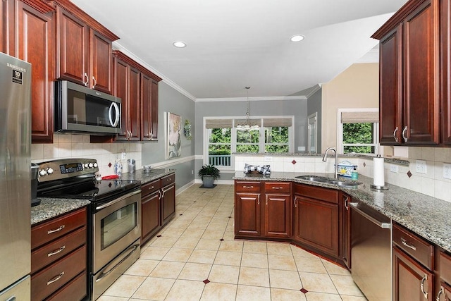 kitchen with backsplash, sink, stainless steel appliances, and dark stone counters