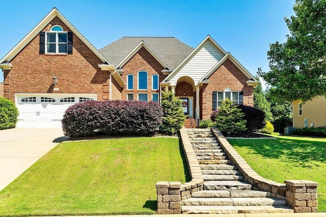 view of front of home featuring a front yard and a garage