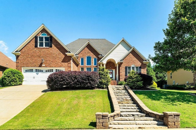 view of front of property featuring a garage and a front lawn