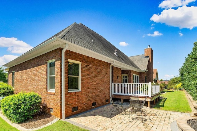 back of property with a patio area, a yard, and a deck