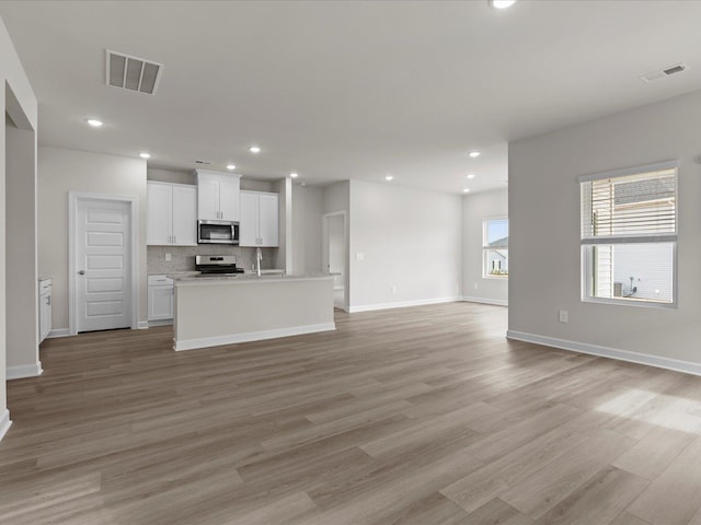 unfurnished living room with light wood-type flooring