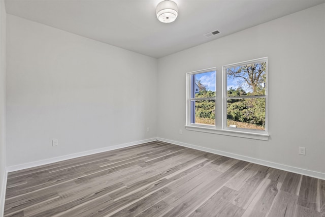 unfurnished room with light wood-type flooring