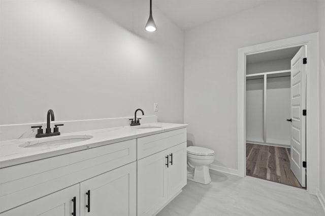 bathroom featuring hardwood / wood-style floors, vanity, and toilet