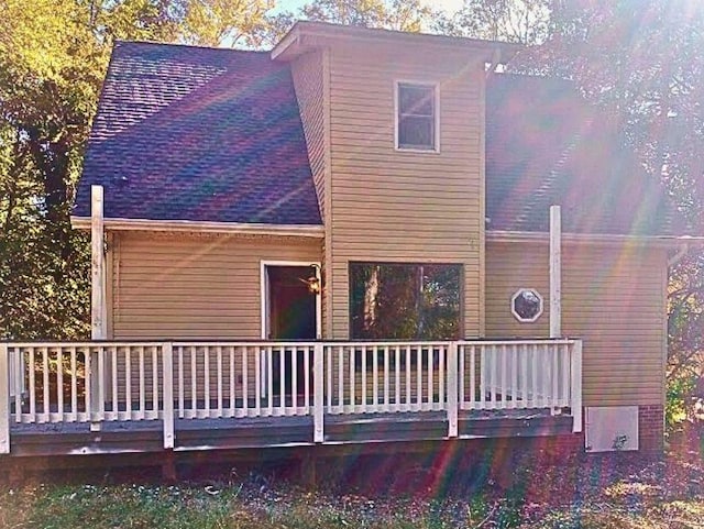 back of property with a wooden deck