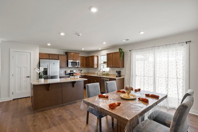 dining area with dark wood-type flooring and sink