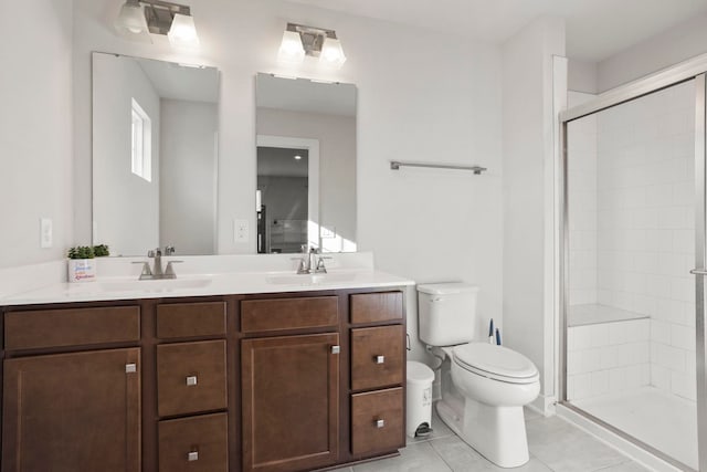 bathroom featuring toilet, vanity, tile patterned floors, and an enclosed shower