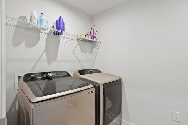 laundry area with independent washer and dryer