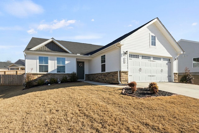 view of front of home with a front lawn and a garage