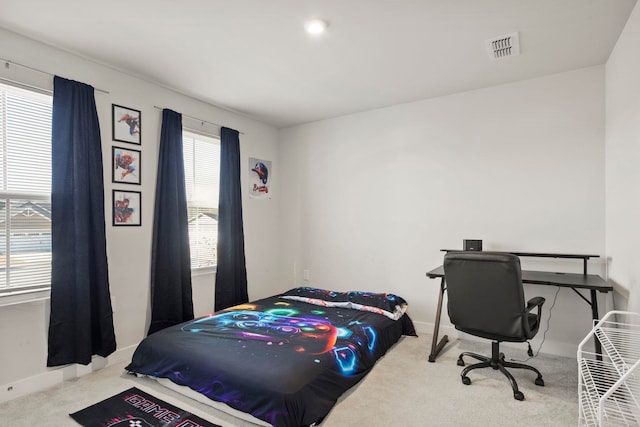 bedroom featuring carpet floors and multiple windows