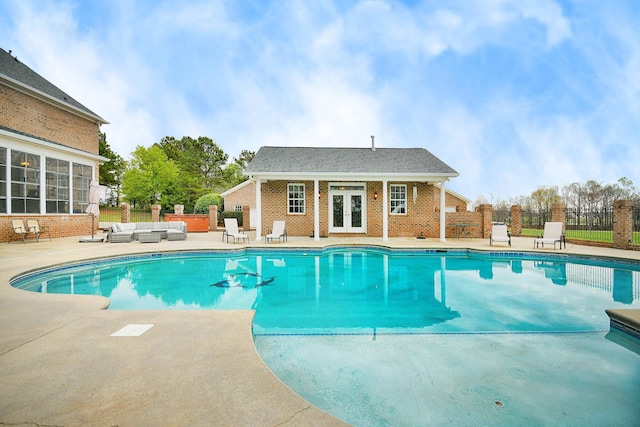 view of swimming pool with a patio area and french doors