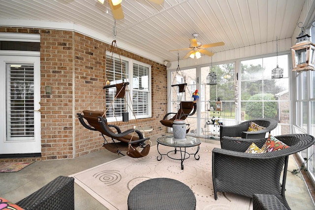 sunroom / solarium featuring ceiling fan