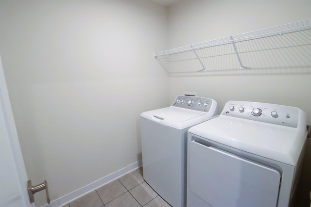 washroom with independent washer and dryer and light tile patterned floors