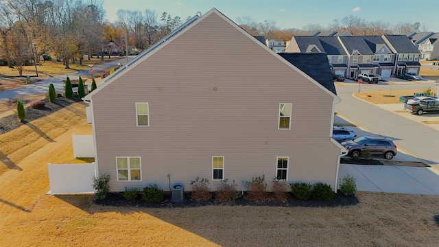 view of side of home with central AC unit