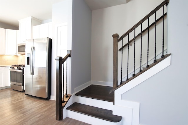 stairs with wood-type flooring