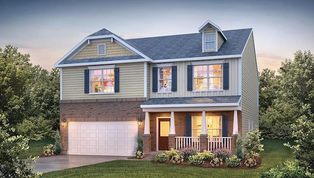 craftsman-style house with a yard, covered porch, and a garage