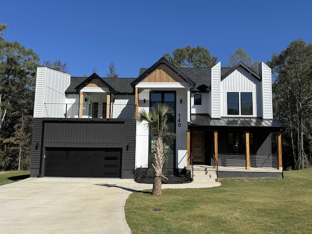 modern inspired farmhouse with a porch, a balcony, a front yard, and a garage