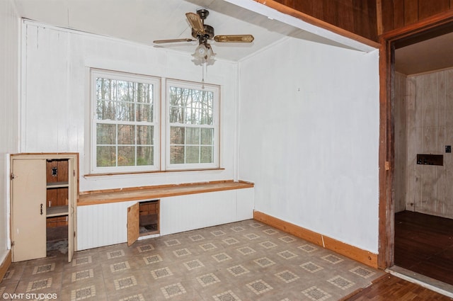 spare room featuring ceiling fan, dark wood-type flooring, and ornamental molding