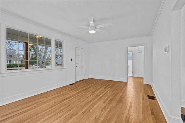 empty room with light hardwood / wood-style flooring, ceiling fan, and ornamental molding