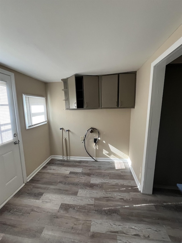 clothes washing area featuring hardwood / wood-style floors