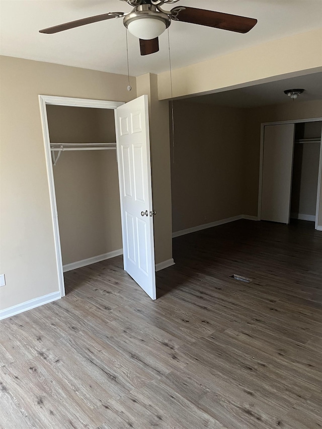 unfurnished bedroom with ceiling fan and hardwood / wood-style floors