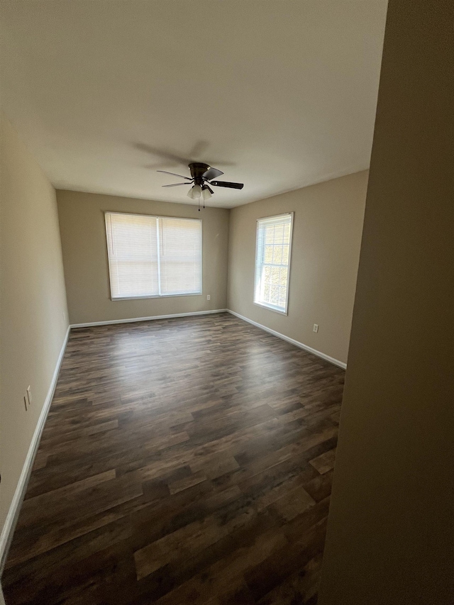 unfurnished room featuring ceiling fan and dark hardwood / wood-style floors