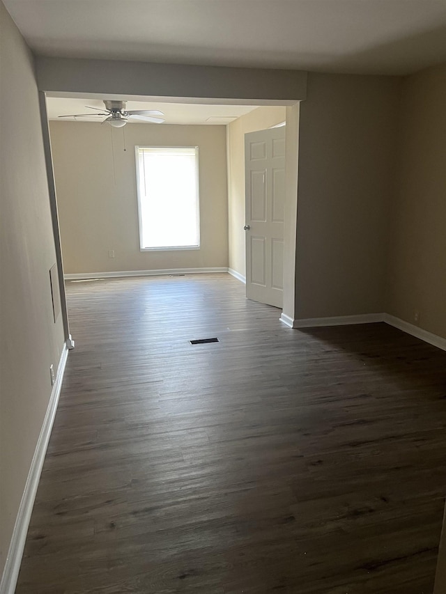 spare room with dark hardwood / wood-style floors and ceiling fan