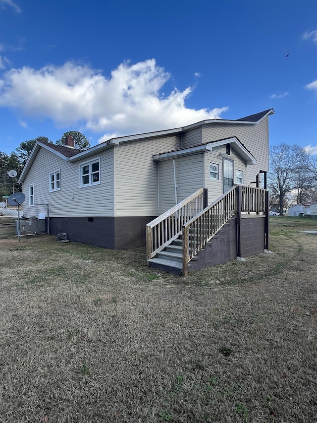 back of house with a lawn