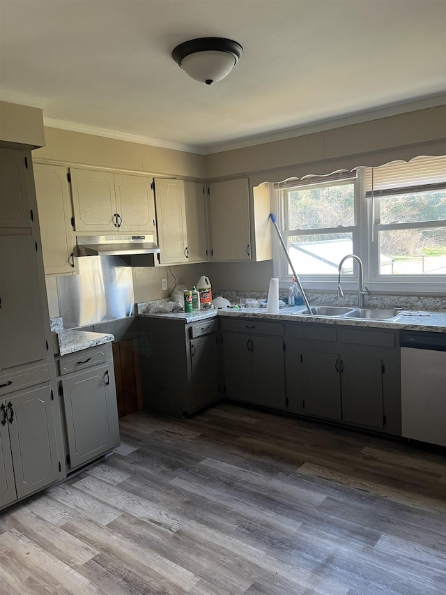 kitchen with dishwasher, crown molding, sink, light stone countertops, and light hardwood / wood-style floors