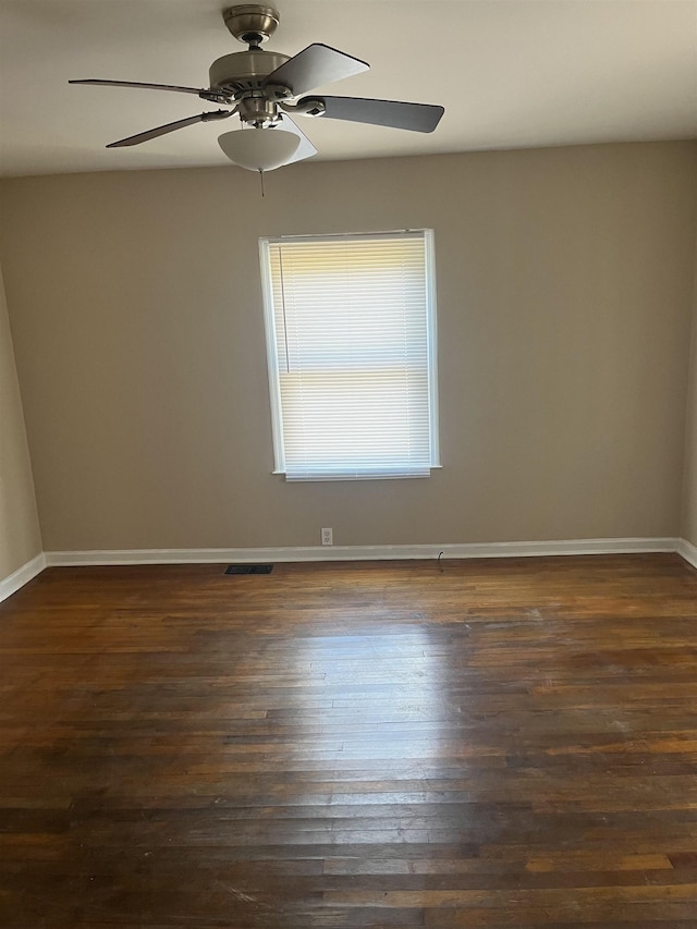 spare room with ceiling fan and dark wood-type flooring