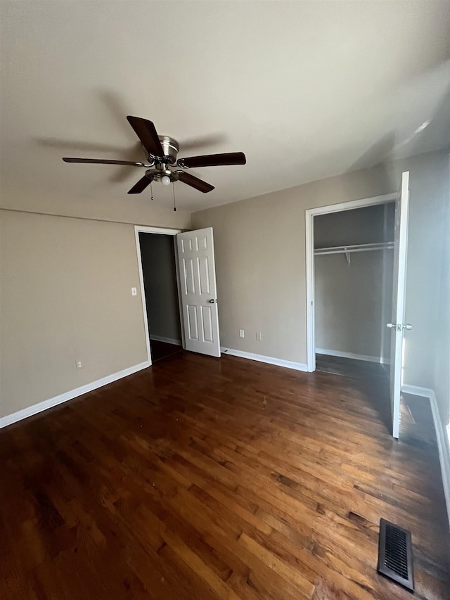 unfurnished bedroom featuring ceiling fan, a closet, and dark hardwood / wood-style floors