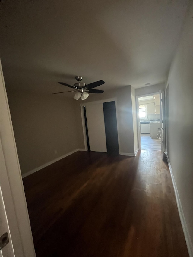 spare room with ceiling fan and dark wood-type flooring