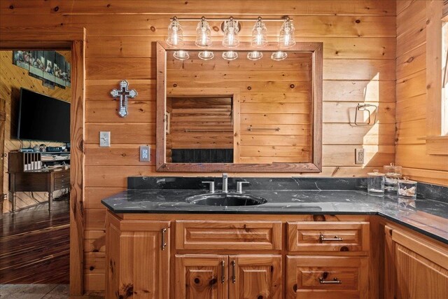 bathroom with vanity and wood walls