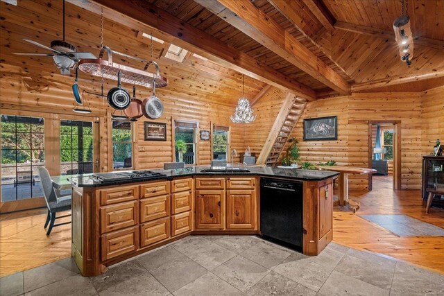 kitchen with dishwasher, a skylight, rustic walls, and sink