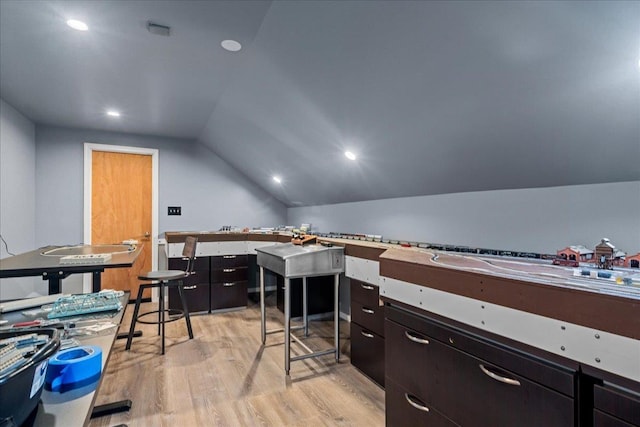 office space with light hardwood / wood-style floors and vaulted ceiling