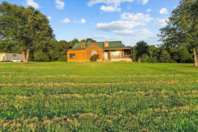 view of front of house with covered porch and a front lawn