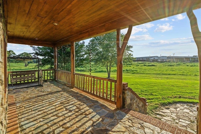 wooden deck featuring a yard and covered porch