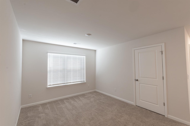 unfurnished room featuring carpet flooring and baseboards