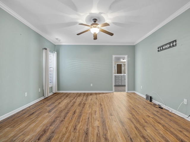 unfurnished room with hardwood / wood-style flooring, ceiling fan, and crown molding