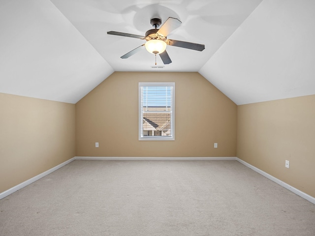 additional living space with ceiling fan, light carpet, and lofted ceiling