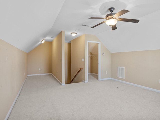 additional living space featuring light colored carpet, ceiling fan, and lofted ceiling