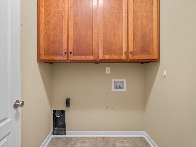 washroom with washer hookup, hookup for an electric dryer, and cabinets