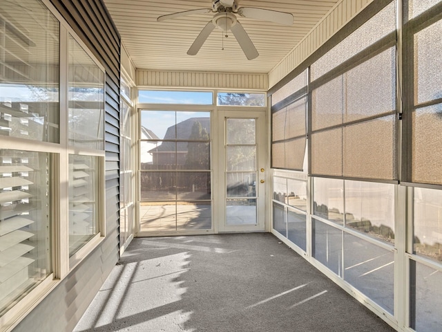 unfurnished sunroom with ceiling fan